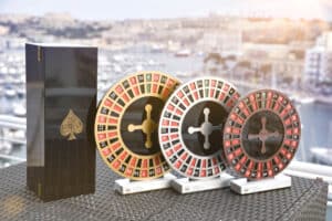 Three custom trophies personalised with bespoke print, posed on a sunny balcony for the European Championship of Roulette Awards